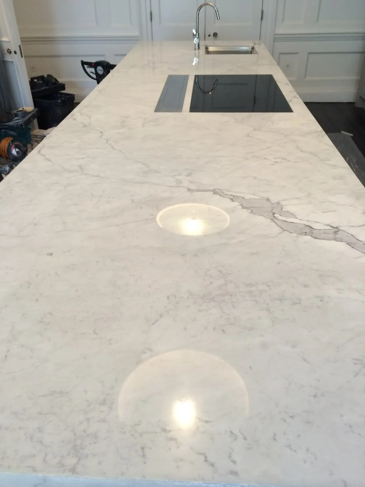 Carrara marble kitchen island after etch removal and polishing