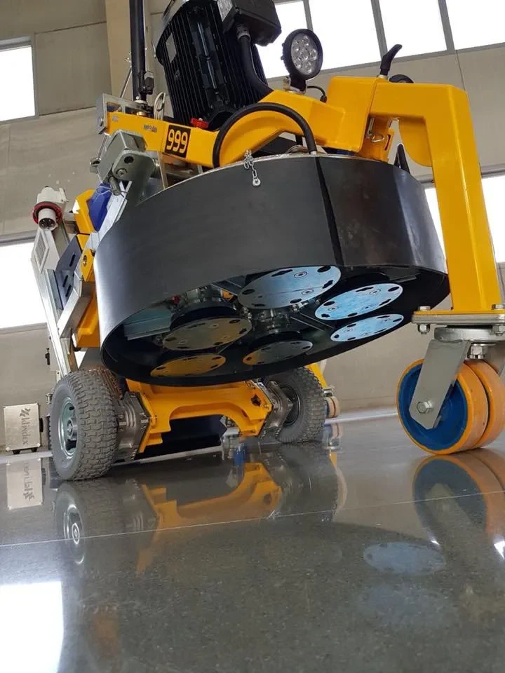Industrial planetary floor grinder with diamond tooling on polished concrete